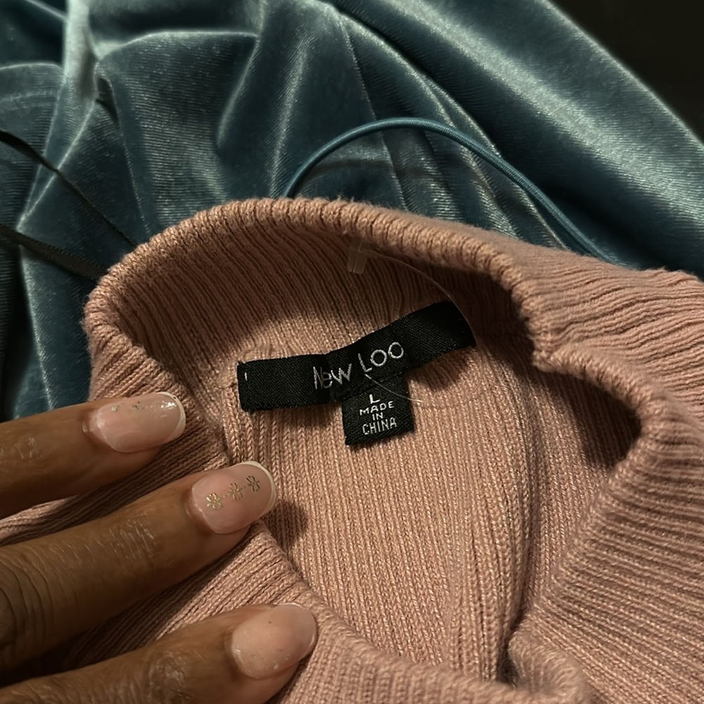 A pink sweater, body con dress with long sleeves no rips or tears